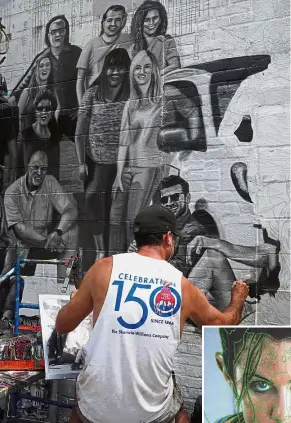  ?? — AFP ?? Eye-catching designs: A painter working on an ad on the side of Colossal Media’s office building in New York. (Inset) A freelance pattern maker burning a pattern to paper at Colossal Media’s office.