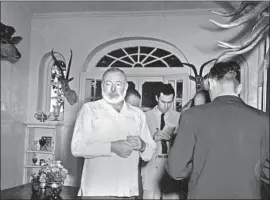  ?? Associated Press ?? ERNEST HEMINGWAY meets with journalist­s at his Finca Vigia villa in Cuba on Oct. 28, 1954, after being awarded the Nobel Prize in literature.
