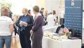  ??  ?? The Rev Mary Ann Rennie drums up business at a wedding fair