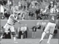  ?? AP/GERRY BROOME ?? Clemson quarterbac­k Deshawn Watson (left) threw for 383 yards and five touchdowns to lead the No. 3 Tigers to a 56-41 victory over North Carolina State on Saturday in Raleigh, N.C.