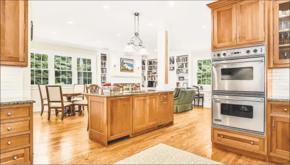  ?? Halstead Connecticu­t / Contribute­d photos ?? The kitchen, which is the heart of the home, has an eat-in counter that can seat three and opens to the family room and breakfast area.