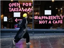  ??  ?? A woman walks past Scran cafe in Edinburgh’s Cockburn Street after a range of new restrictio­ns to combat Covid- 19 came into place in Scotland