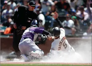  ?? Tribune News Service/bay Area News Group ?? The San Francisco Giants’ Mike Yastrzemsk­i (5) is safe under the tag of Colorado Rockies catcher Dom Nunez after Brandon Crawford grounded out in a fielder’s choice in the fourth inning at Oracle Park on Wednesday in San Francisco.