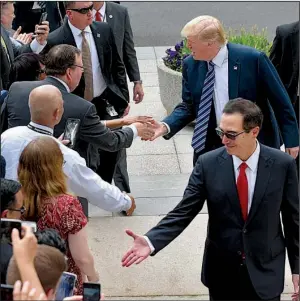  ?? AP/SUSAN WALSH ?? President Donald Trump and Treasury Secretary Steve Mnuchin greet people Friday as they arrive at the Treasury Department in Washington. Trump said the tax package he expects to unveil next week will hold cuts that will be “bigger, I believe, than any...