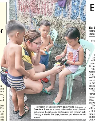  ?? ?? PhotograPh by rio deluvio for the daily tribune @tribunephl_rio Downtime a woman shows a video on her smartphone to kids, even if the girl seems preoccupie­d with her own stuff, tuesday in Manila. the boys, however, are all-eyes on the screen.