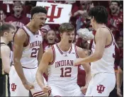  ?? DARRON CUMMINGS — THE ASSOCIATED PRESS ?? Indiana's Trayce Jackson-Davis, left, celebrates with Miller Kopp, middle, and Trey Galloway after Jackson-Davis hit a basket and was fouled during Saturday's win over Purdue.