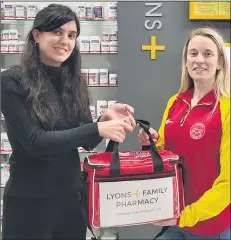  ?? ?? Niamh Towey (right) receiving a First Aid donation from Claudia Leston, Lyons Family Pharmacy, Fermoy.