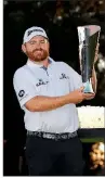  ?? AP/ RYAN KANG ?? J. B. Holmes holds the trophy after winning the Genesis Open by one stroke over Justin Thomas on Sunday.