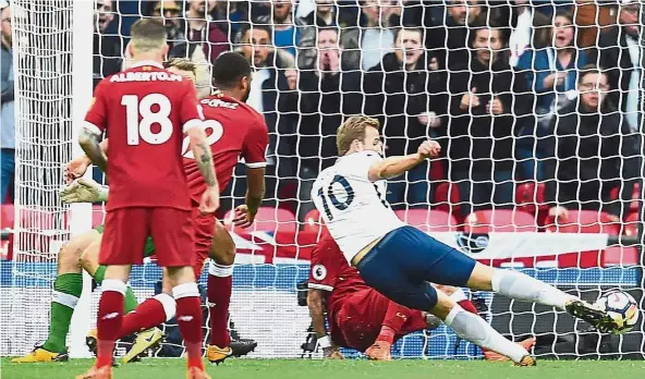  ?? — AFP ?? Making Spurs’ day: Tottenham Hotspur’s Harry Kane scoring the fourth goal against Liverpool in the English Premier League match at Wembley yesterday. Tottenham won 4-1. Below: Son Heung-min celebratin­g with Kane after scoring the second goal.