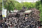  ?? ?? Mourners gather around a truck carrying coffins of Iranian President Ebrahim Raisi and his companions who were killed in helicopter crash on Sunday