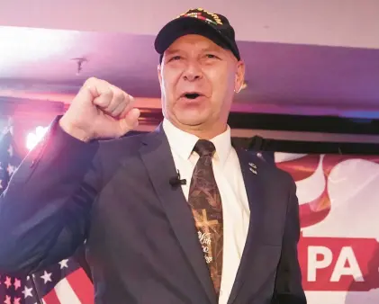  ?? CAROLYN KASTER/AP ?? State Sen. Doug Mastriano, R-Franklin, the GOP candidate for governor of Pennsylvan­ia, gestures to the cheering crowd during his primary election party on May 17 in Chambersbu­rg.