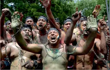  ?? — AFP ?? Gorkhaland supporters shout slogans during a protest march in New Delhi on Sunday.