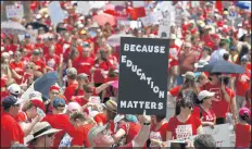  ?? ROSS D. FRANKLIN/AP ?? Thousands march to the Arizona Capitol for higher teacher pay and school funding last year in Phoenix. Teachers staged a six-day walkout after years of poor school funding.