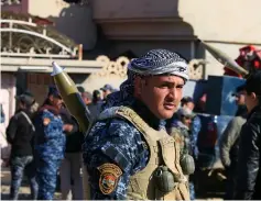  ??  ?? A member of the Iraq’s Federal Police forces takes part during a battle with Islamic State militants in village of Albu Saif, south of Mosul,Iraq. — Reuters photo