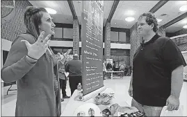  ?? SRAKOCIC/THE ASSOCIATED PRESS] [KEITH ?? A recruiter for a driller in the shale gas industry, left, speaks with a man attending a job fair in Cheswick, Pennsylvan­ia. In many cases, employers say they’re struggling to find enough qualified workers to hire.