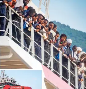  ??  ?? Packed: Migrants aboard the ship wait to disembark