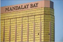  ?? JOHN LOCHER/AP PHOTO ?? In this Oct. 2 photo, drapes billow out of broken windows at the Mandalay Bay resort and casino on the Las Vegas Strip, following a deadly shooting at a music festival in Las Vegas.