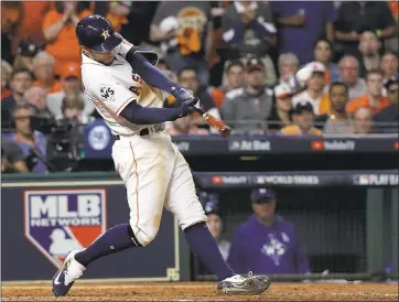  ?? DAVID J. PHILLIP — THE ASSOCIATED PRESS ?? Houston’s George Springer hits a home run in the seventh inning Sunday, one of 22 homers hit in the first five games.