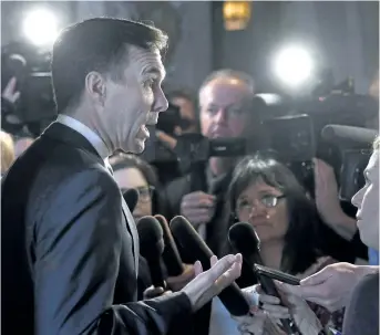  ?? JUSTIN TANG/THE CANADIAN PRESS ?? Finance Minister Bill Morneau speaks to reporters after leaving a cabinet meeting on Parliament Hill in Ottawa on Feb. 6. The Liberal government has said improving the economic success of women and promoting gender equality will be primary objectives...