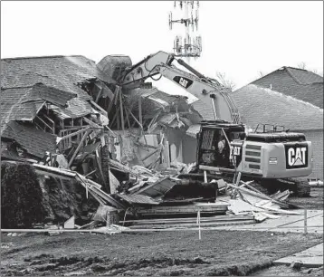  ?? CLARENCE TABB JR./DETROIT NEWS 2017 ?? A house in Fraser, Mich. is demolished to help clear the way for repairs to a broken sewer line. Officials say Fraser’s infrastruc­ture needs could hold back economic growth.