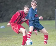  ??  ?? A Charlie Accies player (blue) holds off a challenge in the side’s meeting with Annfield.