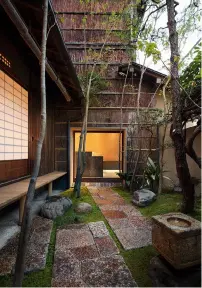  ??  ?? At the main branch of Honke Owariya, located on Niomontsuk­inukecho in Kyoto, a wall of glass (above) showcases the minimalist interior of its new outlet dedicated solely to soba sweets, while a side door (left) crosses a threshold of graphic tiles to lead into a walled garden