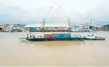  ??  ?? Arrival of the first containers via a barge near the 2nd Niger Bridge in Onitsha