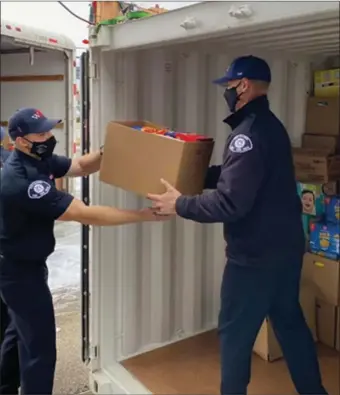  ??  ?? West Kelowna firefighte­rs gather donations in this year’s food bank drive.