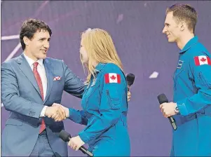  ?? CP PHOTO ?? Prime Minister Justin Trudeau welcomes Canada’s newest astronauts Jennifer Sidey and Joshua Kutryk during Canada 150 celebratio­ns on Parliament Hill in Ottawa on Saturday.