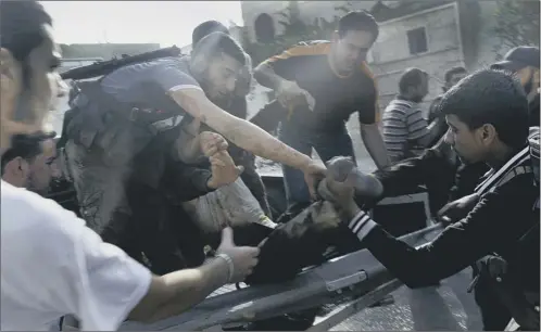  ?? Picture: Getty ?? rebel fighters help an injured comrade from a pickup truck in Qusayr, near Homs, which was shelled by regime forces yesterday