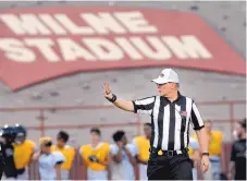  ?? JIM THOMPSON/JOURNAL ?? Referee Steve Livingston signals for the ball as he prepares to place it during Wednesday’s scrimmage at Milne Stadium. There are only about 300 game officials in New Mexico, down about 40 from last year.
