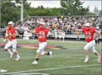  ?? BRITTANY CHAY — THE NEWS-HERALD ?? Mentor’s, from left, Braden Gefert, Brady Benz and James Pedley celebrate during the Cardinals’ 42-39 win over St. Edward on Aug. 24.