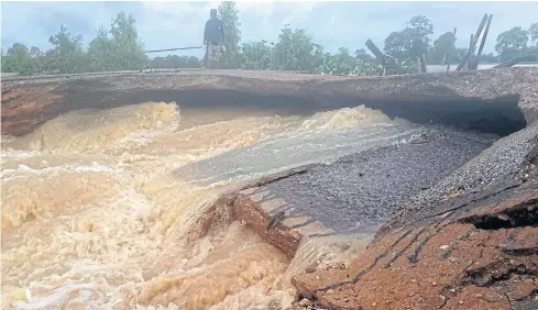  ?? BANGKOK POST PHOTO ?? In this photo from Tuesday, rain-triggered heavy floods cut off a road in Roi Et’s Selaphum district.