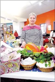  ?? Lynn Atkins/The Weekly Vista ?? Susan Ferraro stands among the 93 baskets she put together out of donated items for the Friends of the Library Fundraiser. The silent auction ends later today.