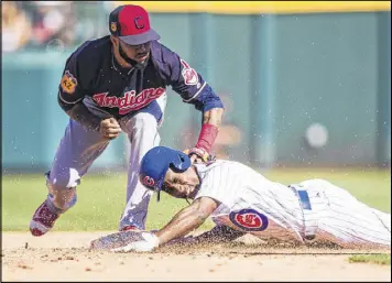  ??  ?? The Cubs’ Jemile Weeks steals second as the Indians’ Ronny Rodriguez is late with the tag in Mesa, Ariz. Sunday’s World Series rematch ended in a tie.