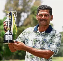  ??  ?? Champion: R. Nachimuthu posing with the trophy after winning the PGM Port Dickson Closed Championsh­ip yesterday.