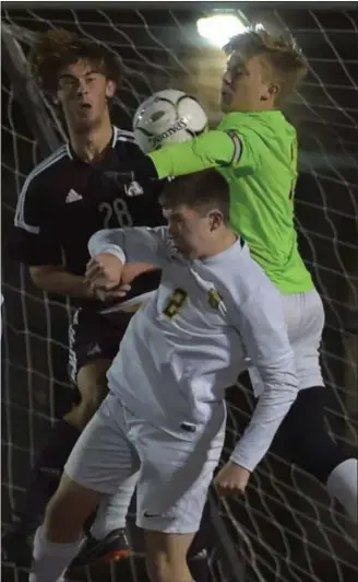  ?? DIGITAL FIRST MEDIA FILE PHOTO ?? Central Bucks West goalie Dylan Smith makes a last-minute save as Abington’s Reese Gibbs looks for the loose ball during the District 1 championsh­ip.