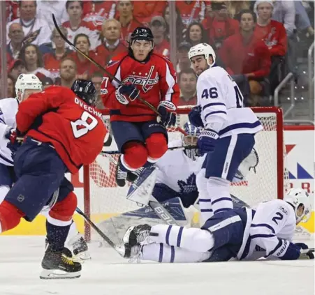  ?? PATRICK SMITH/GETTY IMAGES ?? Leaf Matt Hunwick goes low while Roman Polak battles leaping T.J. Oshie on goalie Frederik Andersen’s doorstep on an Alex Ovechkin blast.