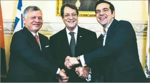  ??  ?? Jordan’s King Abdullah, Greek Cypriot leader Nicos Anastasiad­es and Greek Prime Minister Alexis Tsipras shake hands during a meeting in South Nicosia on Tuesday