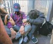  ?? John Gibbins San Diego Union-Tribune ?? MIGRANTS seeking asylum wait at the Otay Mesa border crossing in San Diego in December.