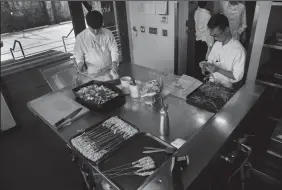  ?? GINA FERAZZI/LOS ANGELESTIM­ES ?? Sous chefs prep for dinner service at Benu, which is considered an environmen­tally friendly zero footprint restaurant in San Francisco, on Wednesday.