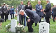  ?? GETTY IMAGES ?? President Donald Trump lays flowers on the grave of DHS Secretary John Kelly's son Robert at Arlington National Cemetery.