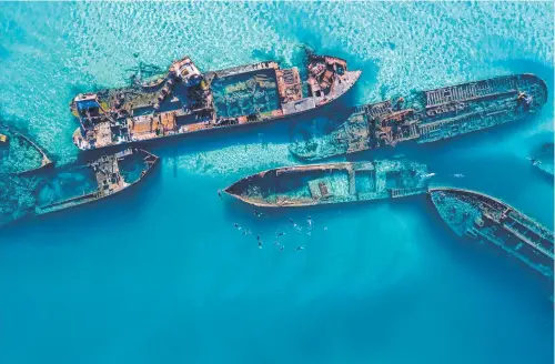  ?? ?? ESCAPE: Submerged wrecks and snorkelers at the Tangalooma Wrecks, Moreton Island.