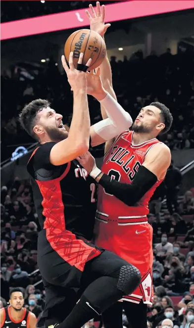  ?? STEVE DYKES/AP ?? Zach LaVine shows off some of what he can do on defense — an area where writers have criticized him in the past — against Trail Blazers center Jusuf Nurkic this week.