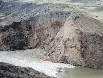  ??  ?? Workers are seen on a cliff at the site of a massive rock slide on the Fraser River near Big Bar, west of Clinton, in July 2019. Officials with the Department of Fisheries and Oceans say early arriving runs of Stuart and chinook salmon were nearly wiped out after reaching the massive landslide.