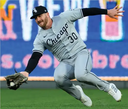  ?? REED HOFFMANN/GETTY IMAGES ?? Robbie Grossman makes a diving catch on a fly ball hit by Vinnie Pasquantin­o of the Royals in the third inning Friday night at Kauffman Stadium.