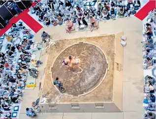  ??  ?? No go zone: Women are not permitted to enter the dohyo, the sumo ring