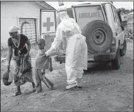  ?? The Washington Post/NIKKI KAHN ?? Mamie Kuyateh (right) helps a 4-year-old boy off an ambulance Tuesday at a holding center in Freetown, Sierra Leone. There is little space in holding centers for Ebola patients, much less hospital beds.