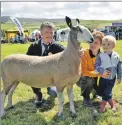  ??  ?? Jean McLachlan’s gimmer, shown by her husband John, was the judges’ choice for the top accolade at the 151st annual show, and can be seen with the couple and their grandson Joshua. 50_c32kintyre­show45