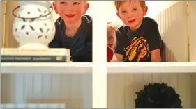  ??  ?? Neighbor Elliott Buzdiak, 3, plays with Leo Kuhl, 6, and his sister Charlie, 3 and peek from behind cupboards that have swing doors. (Richard Tsong-Taatarii/TNS)